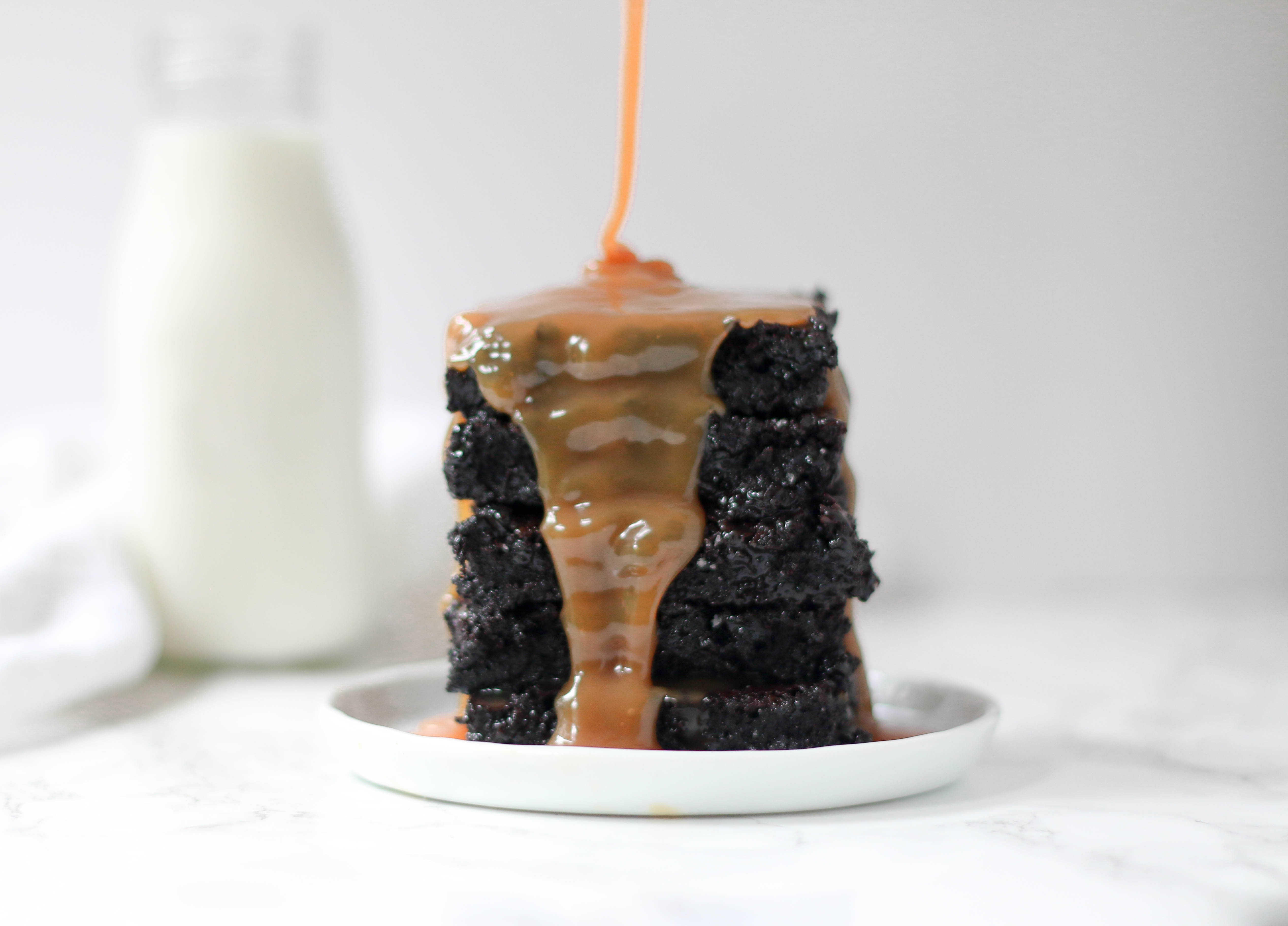 stack of caramel brownies with caramel drizzled over