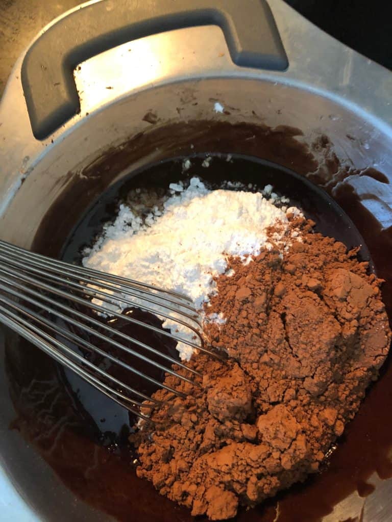 cocoa powder and powdered sugar added to double boiler