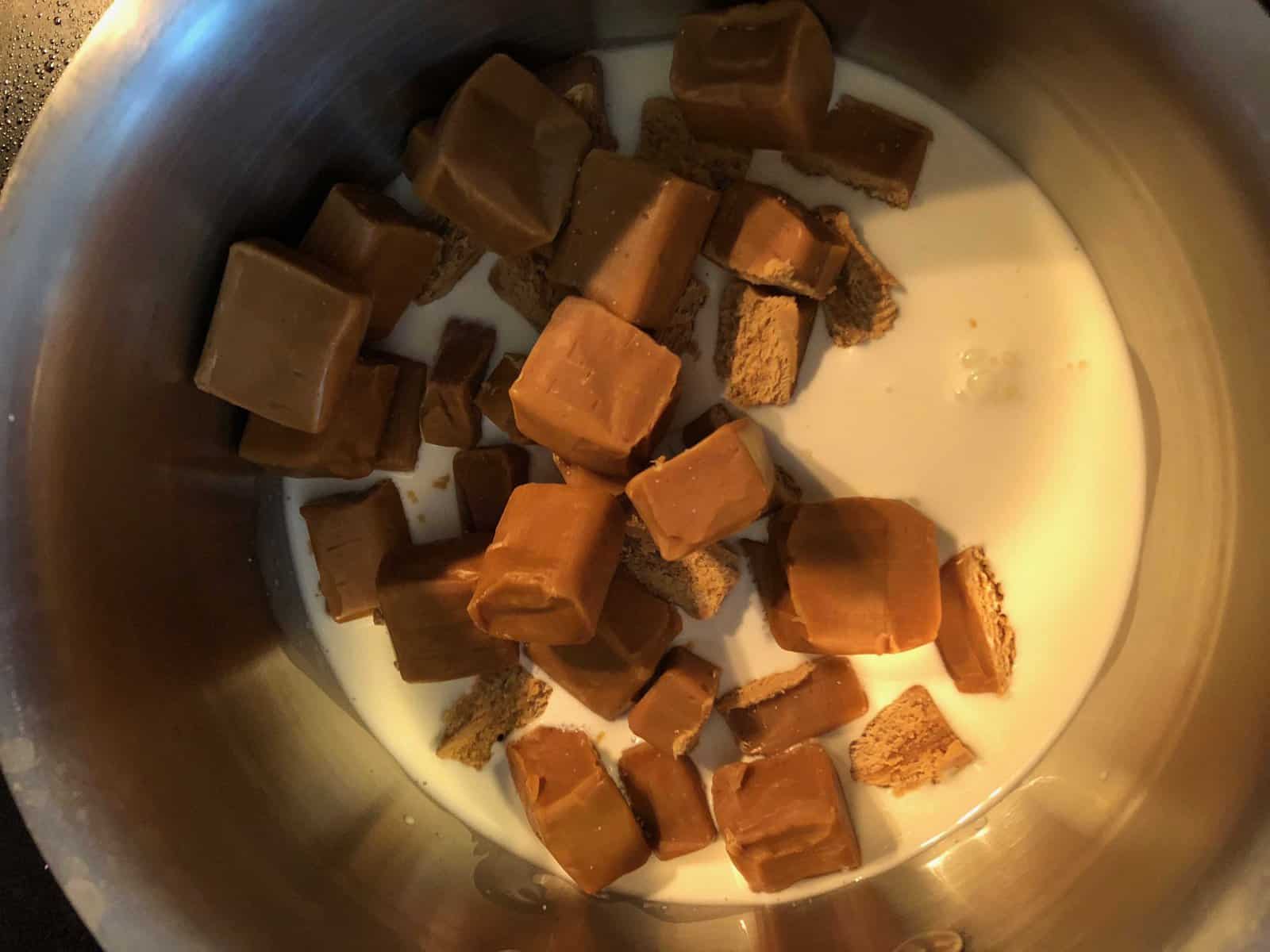 caramel candies and heavy cream in a saucepan