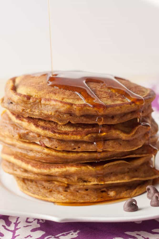 stack of pumpkin pancakes with syrup