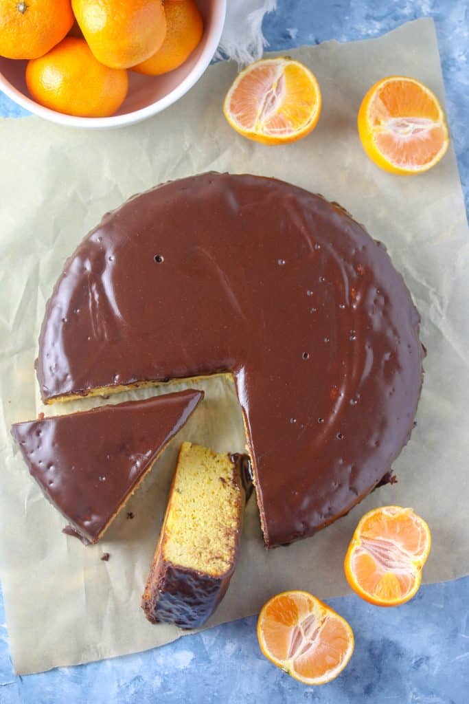 clementine cake on parchment surrounded by clementines