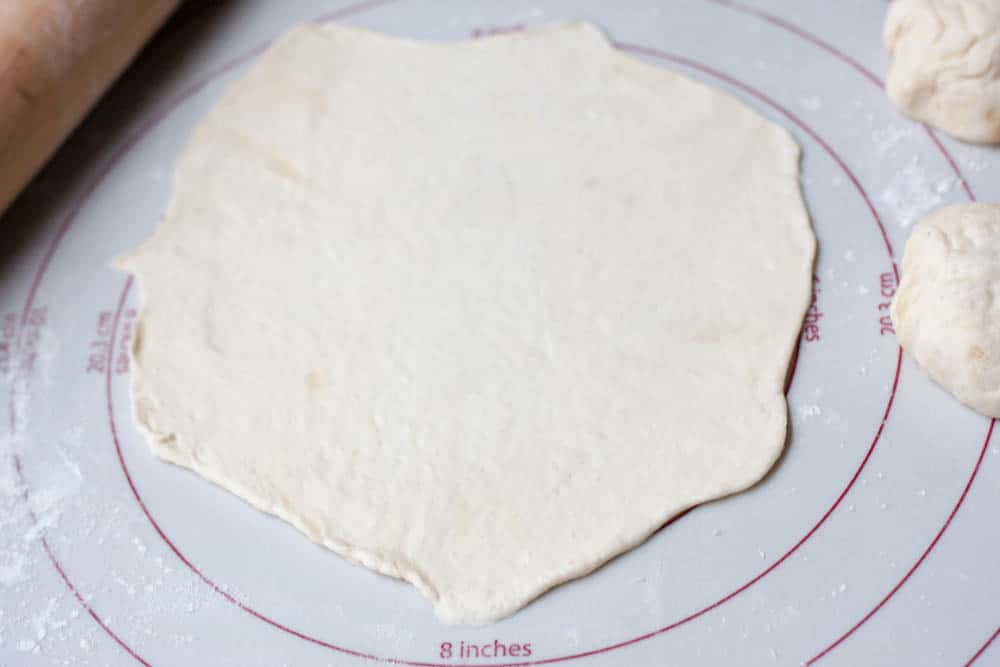 7-inch flour tortilla dough circle on a pastry mat