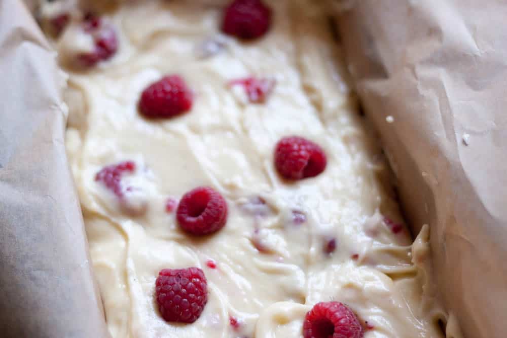 batter with raspberries in a loaf pan