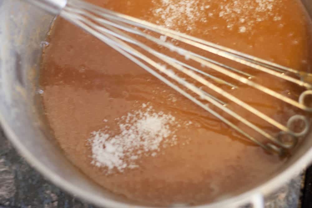 salted caramel sauce being whisked in a pan