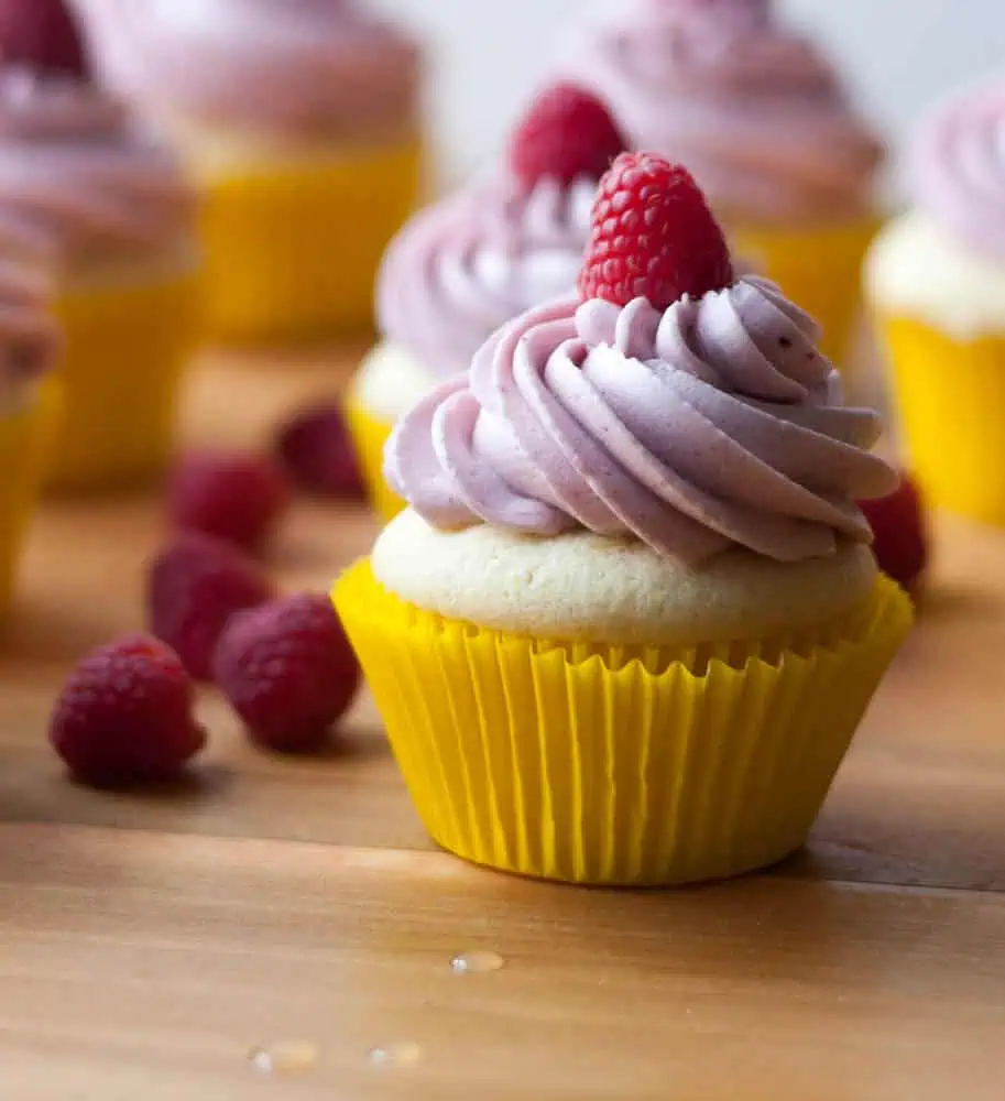 Lemon cupcakes with raspberry buttercream lemon cupcake with raspberry on top