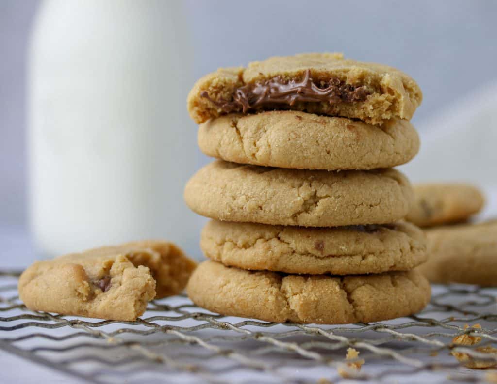 stack of peanut butter nutella stuffed cookies on a cookie sheet