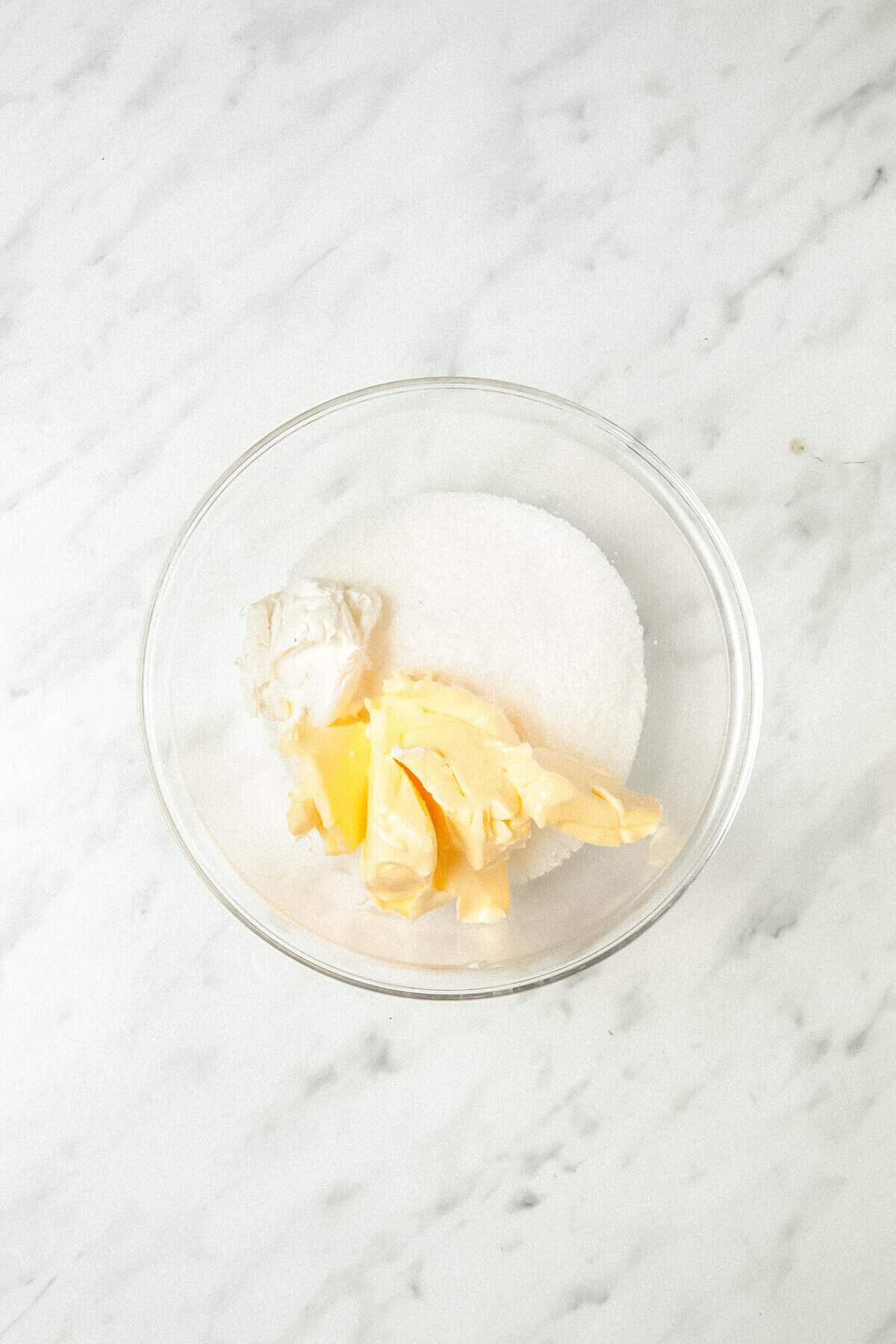 butter, sugar, and cream cheese in a glass bowl