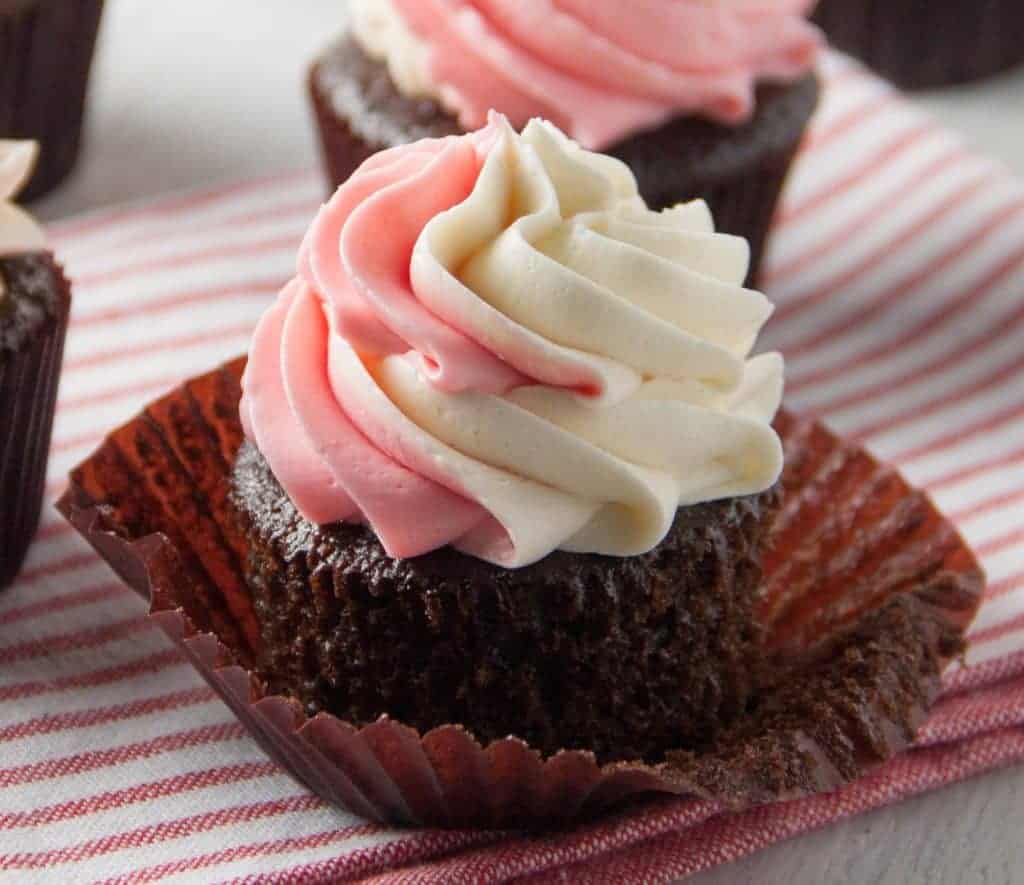 chocolate cupcake with pink and white swirled frosting