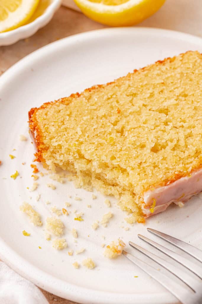 slice of lemon bread on a plate with a bite missing