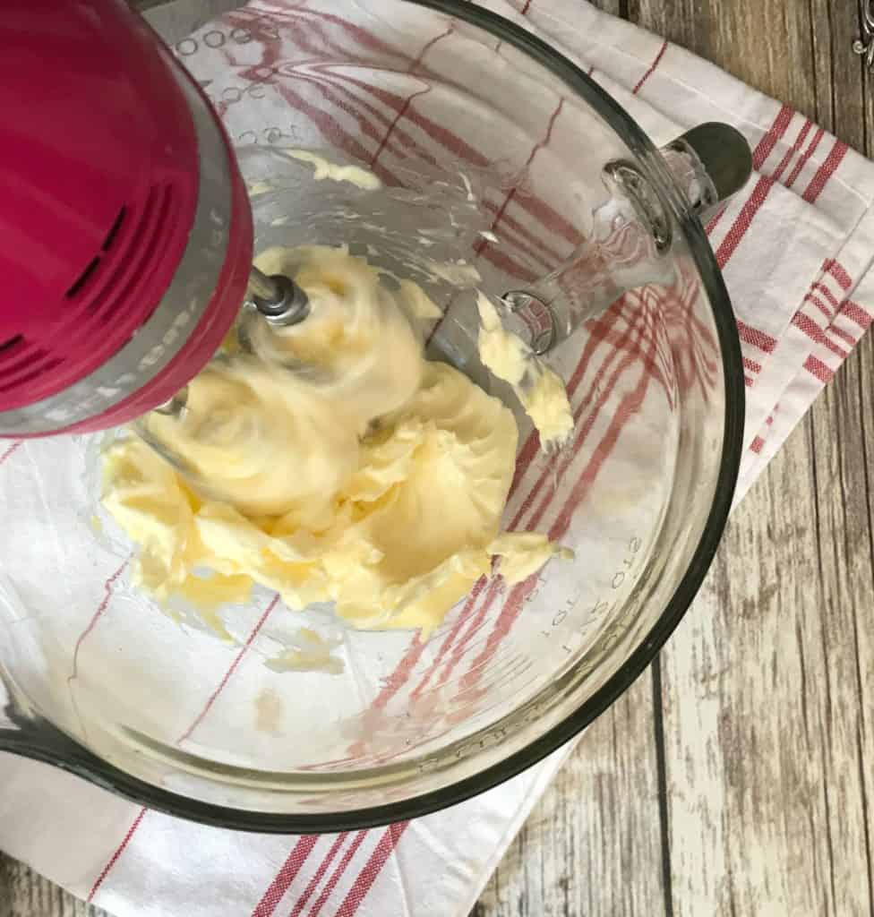 butter in a bowl mixed by a hand mixer for cake batter frosting