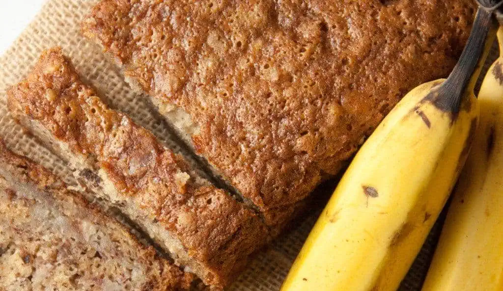Ultimate Guide To Homemade Bread Recipes loaf of banana bread with bananas