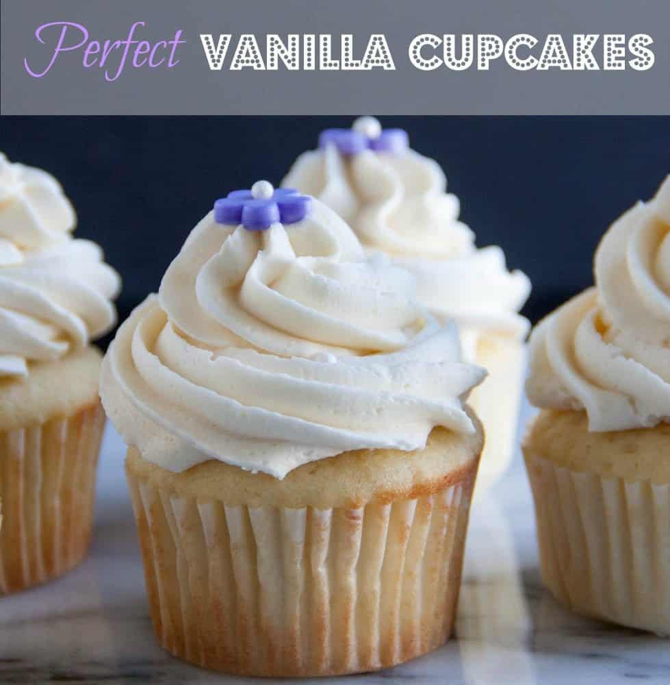 Vanilla cupcake with 3 vanilla cupcakes behind it