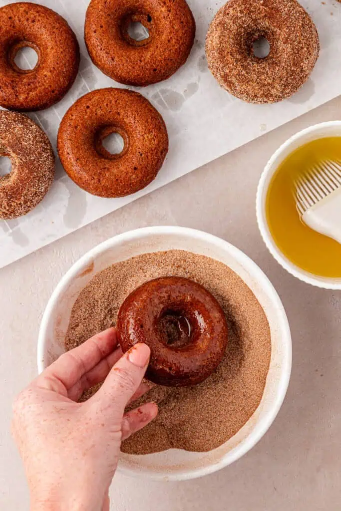 donut dipped in butter then rolled in cinnamon sugar