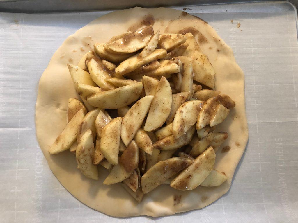 Pie dough topped with apples