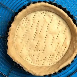 partially baked pie crust on a wire rack