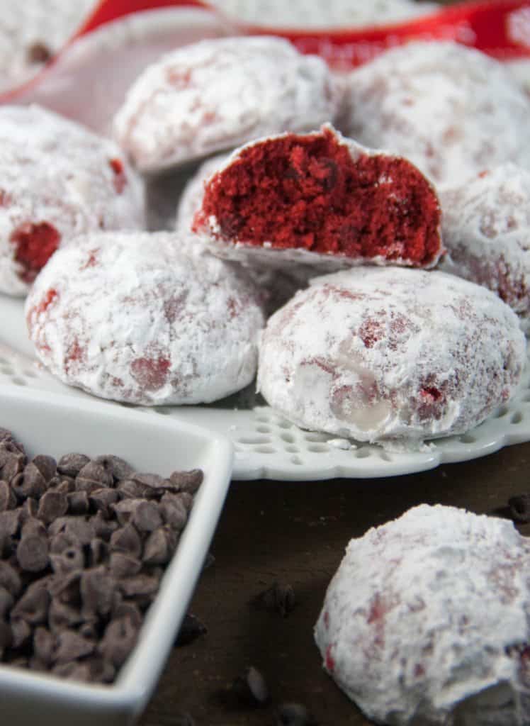red velvet chocolate chip snowball cookies on a plate