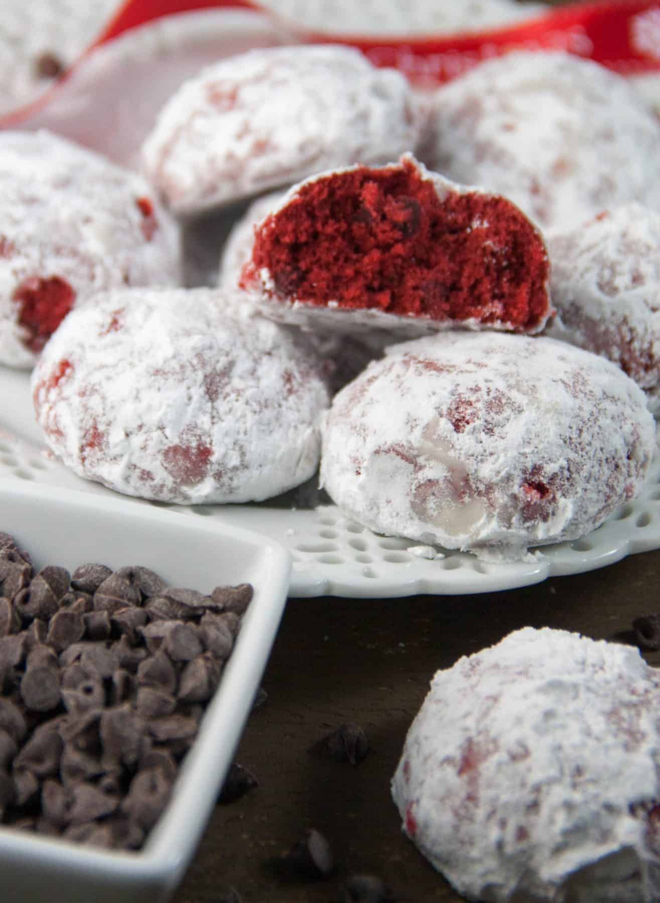 a plate of red velvet snowball cookies