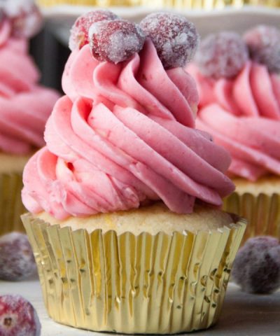 Cupcakes perfect for New Year's Eve with sparkling cranberries and champagne buttercream frosting!
