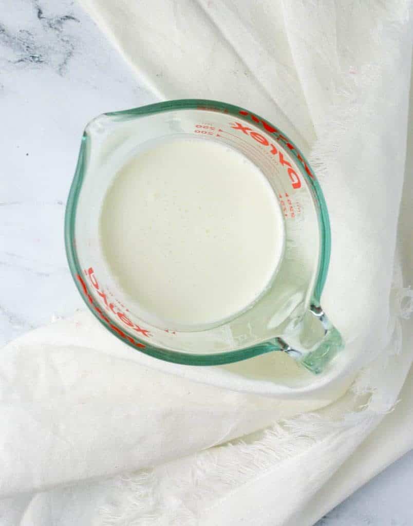 measuring cup of homemade buttermilk