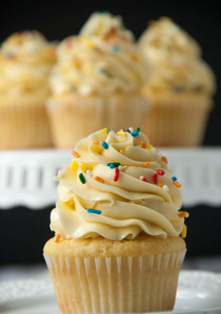 vanilla cupcake with german buttercream and cupcakes in the background
