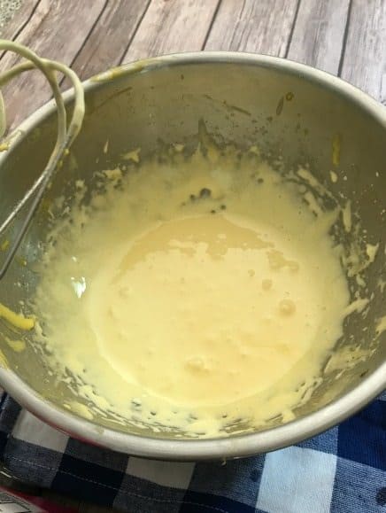 Egg yolks whipped in a metal bowl