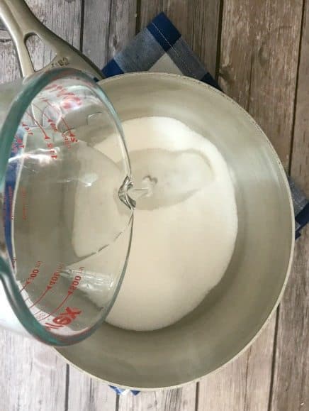 water poured into a saucepan with sugar