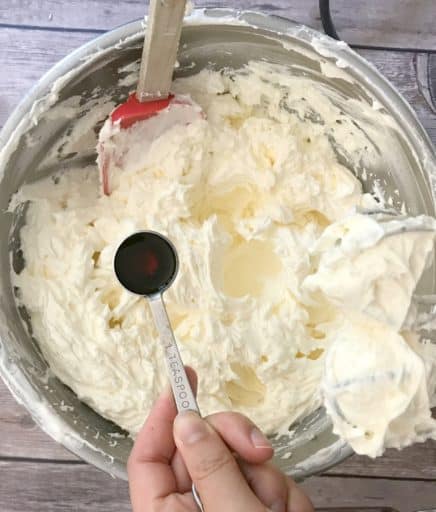 vanilla extract added to bowl of buttercream