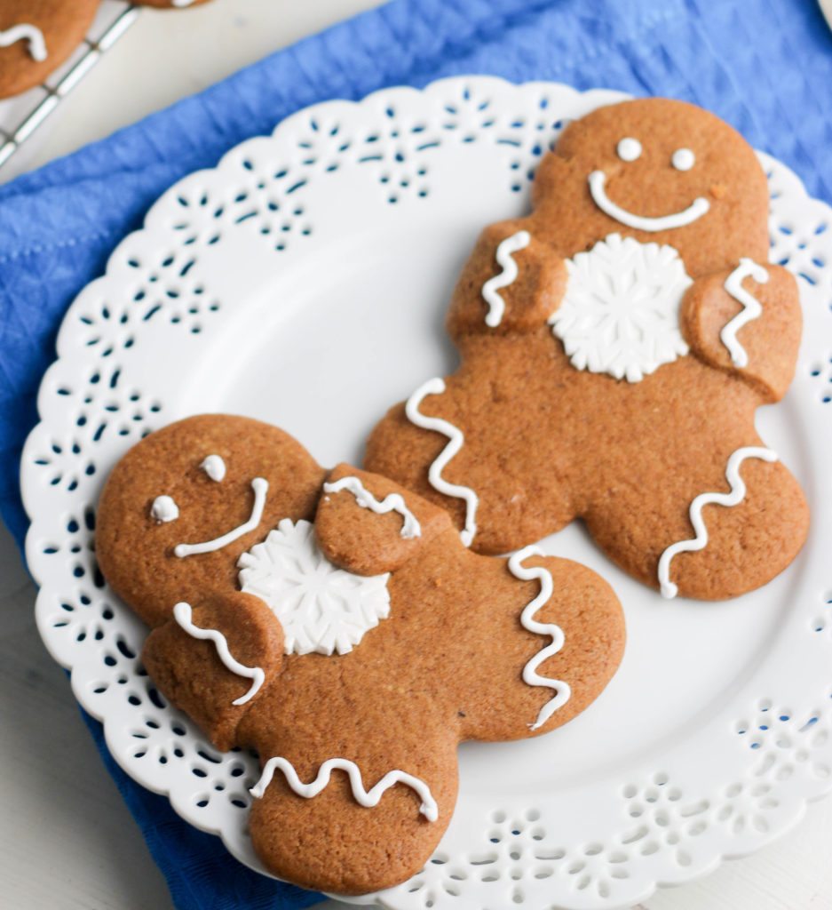 two gingerbread cut out cookies on a plate