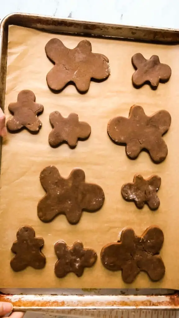 unbaked gingerbread cookies on a baking sheet