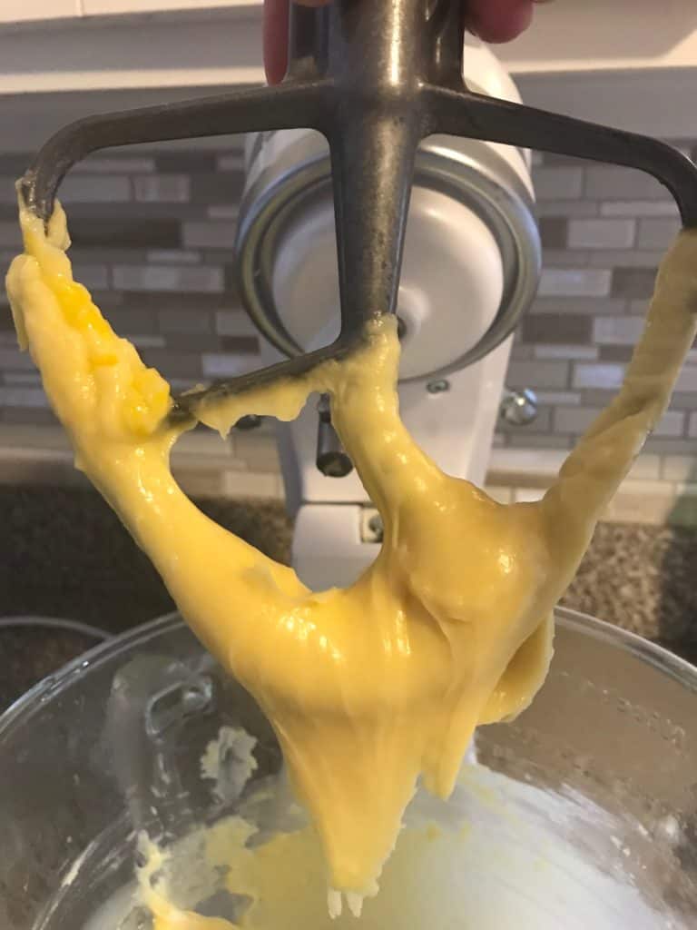 stand mixer paddle attachment with choux pastry on it