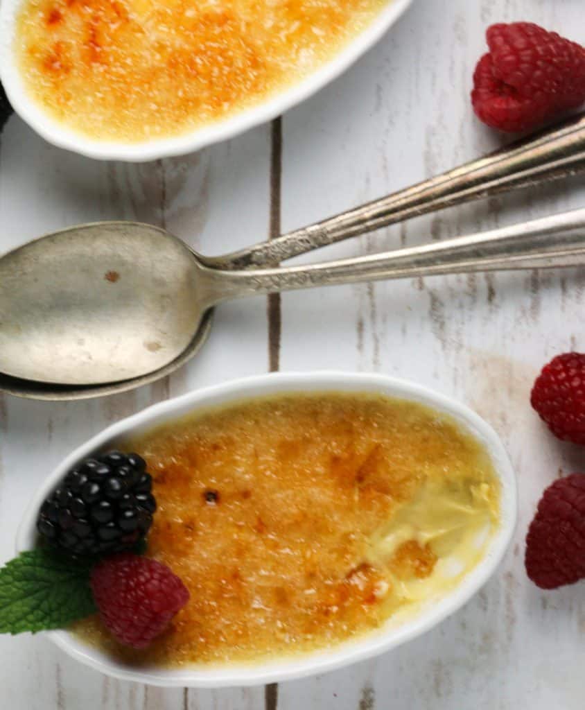 two creme brulees with spoons