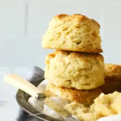 buttermilk biscuits stacked with a knife and butter next to it
