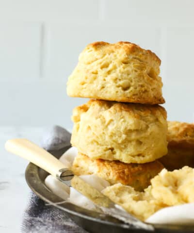 buttermilk biscuits stacked with a knife and butter next to it