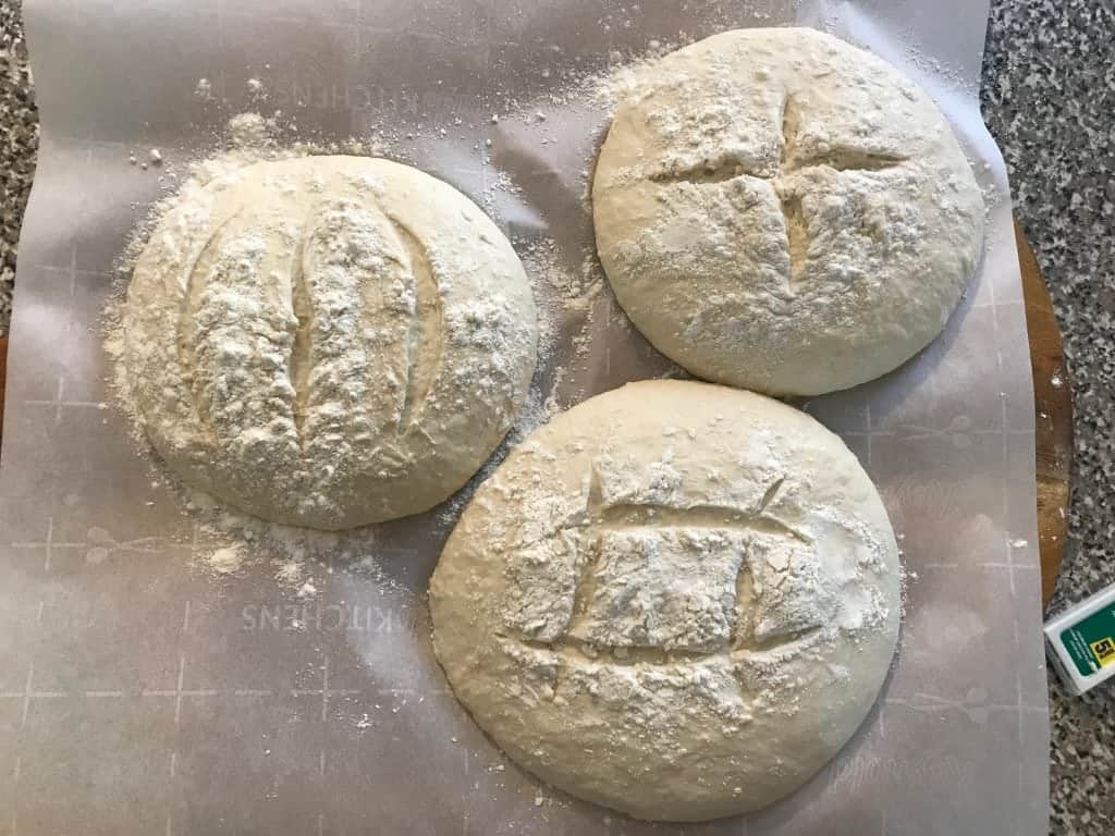 three loaves of bread on parchment