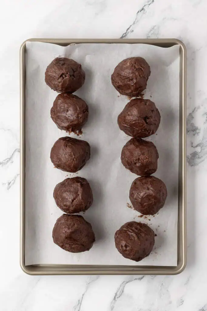 cookie dough balls on a cookie sheet