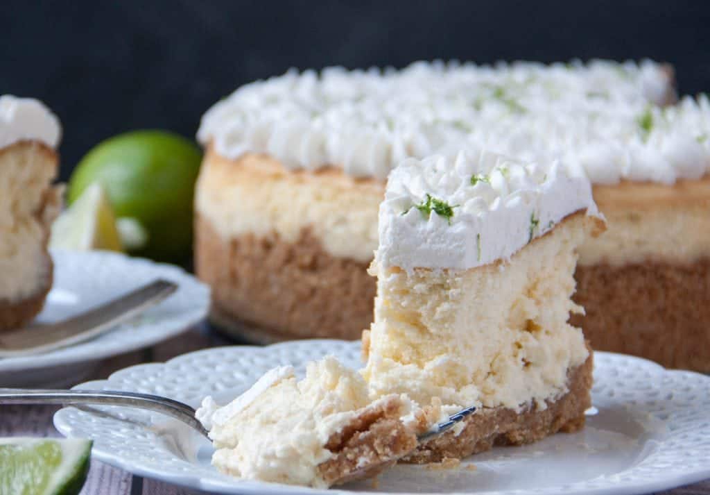 slice of key lime cheesecake on a plate with a fork