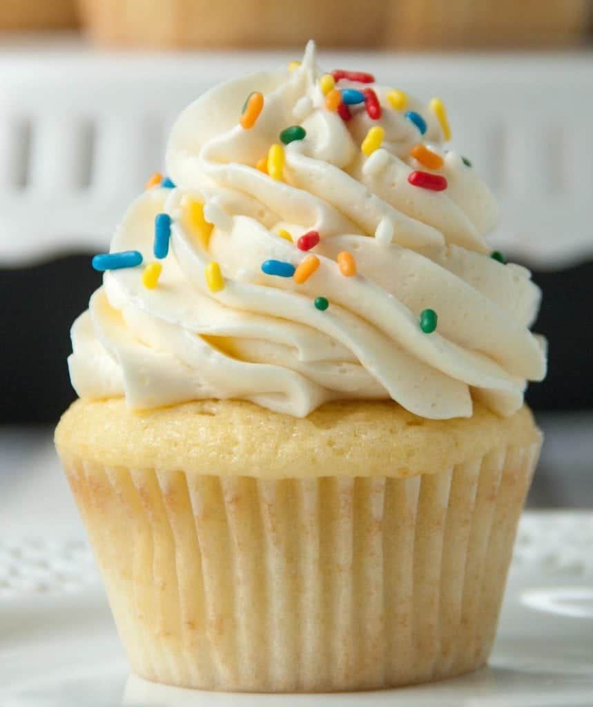 vanilla cupcake with vanilla frosting and sprinkles
