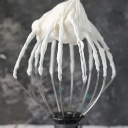 stand mixer whisk attachment with whipped cream on it