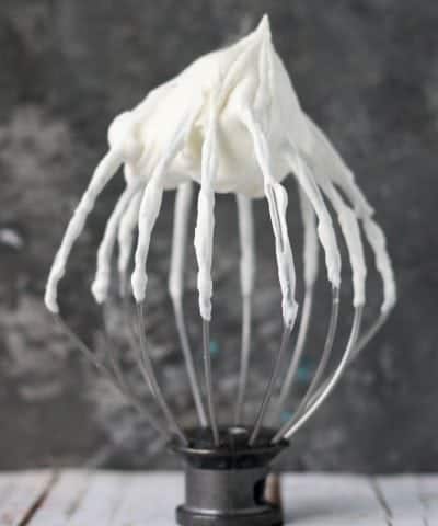 stand mixer whisk attachment with whipped cream on it