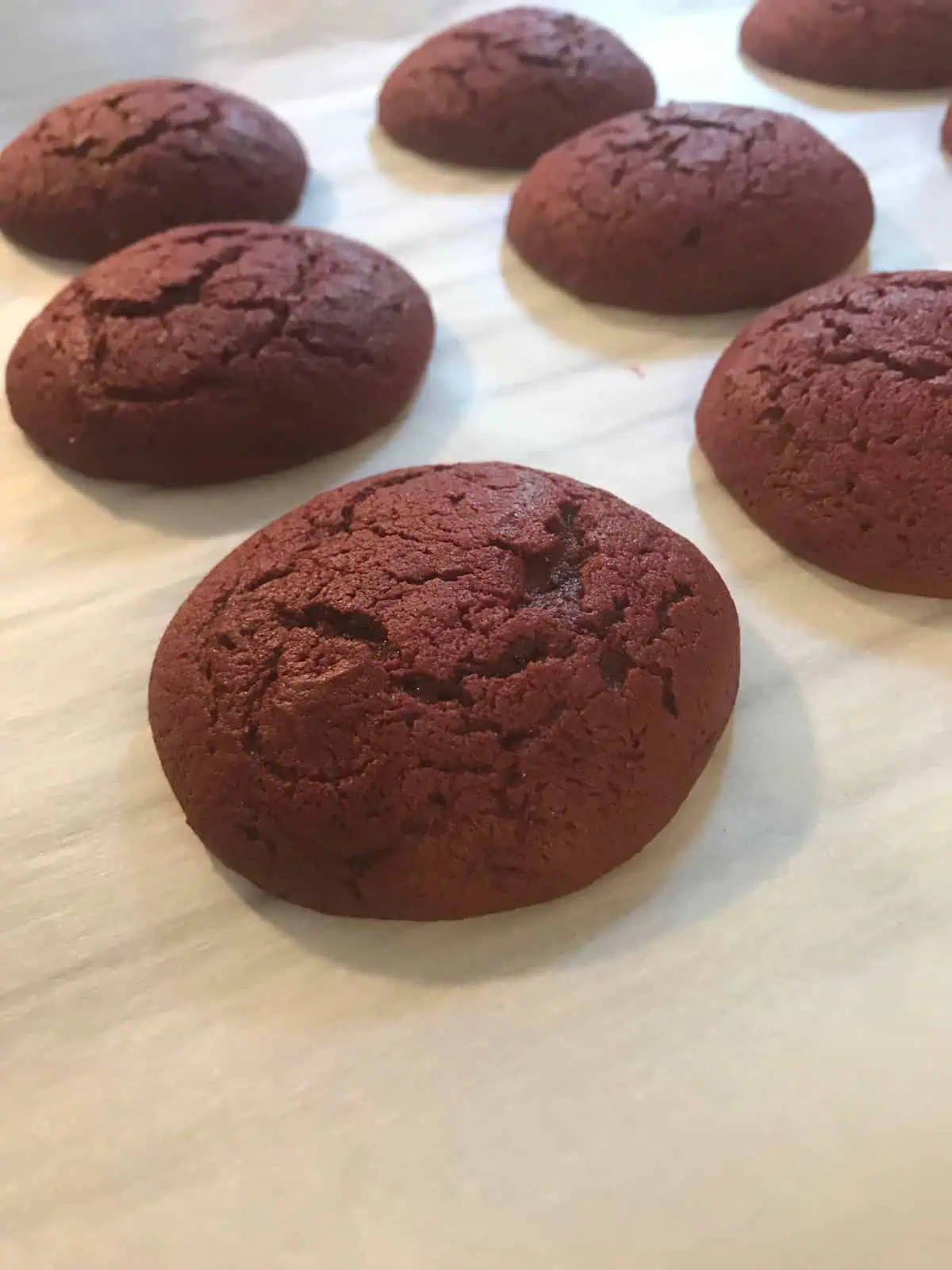 Red Velvet whoopie pies baked red velvet whoopie pies on a cookie sheet