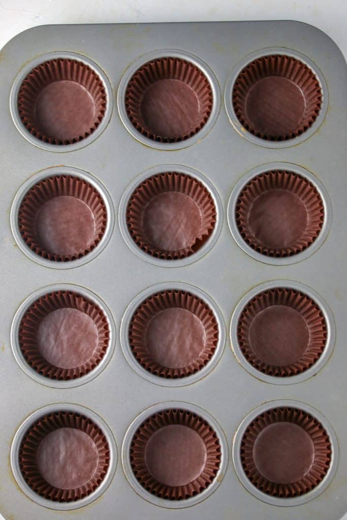 Muffin tin with liners for triple chocolate cupcakes 