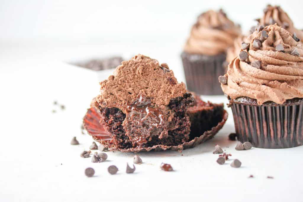 chocolate cupcake topped with ganache frosting and a ganache filling