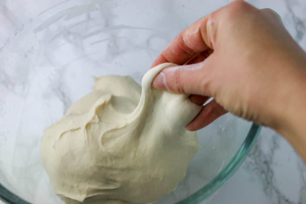 hand stretching the dough