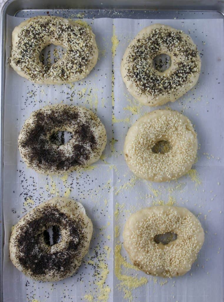 bagels with toppings on parchment paper