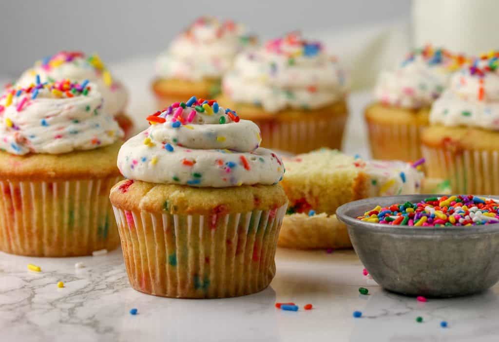Funfetti cupcakes topped with cake batter frosting