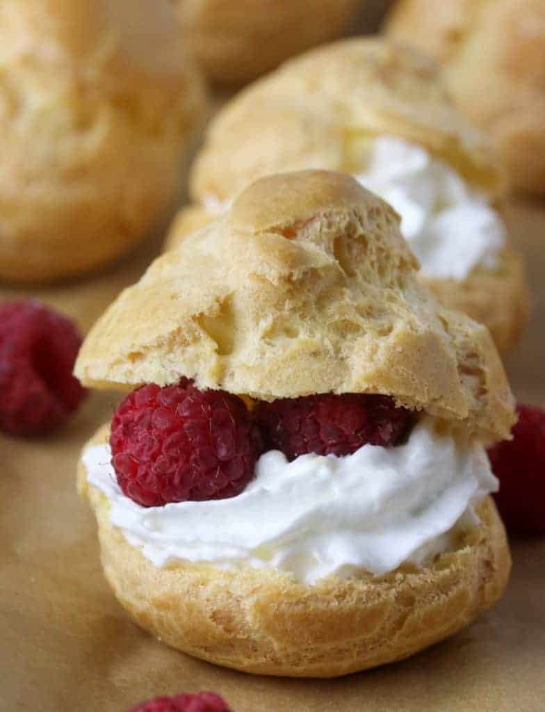 cream puffs filled with whipped cream and raspberries