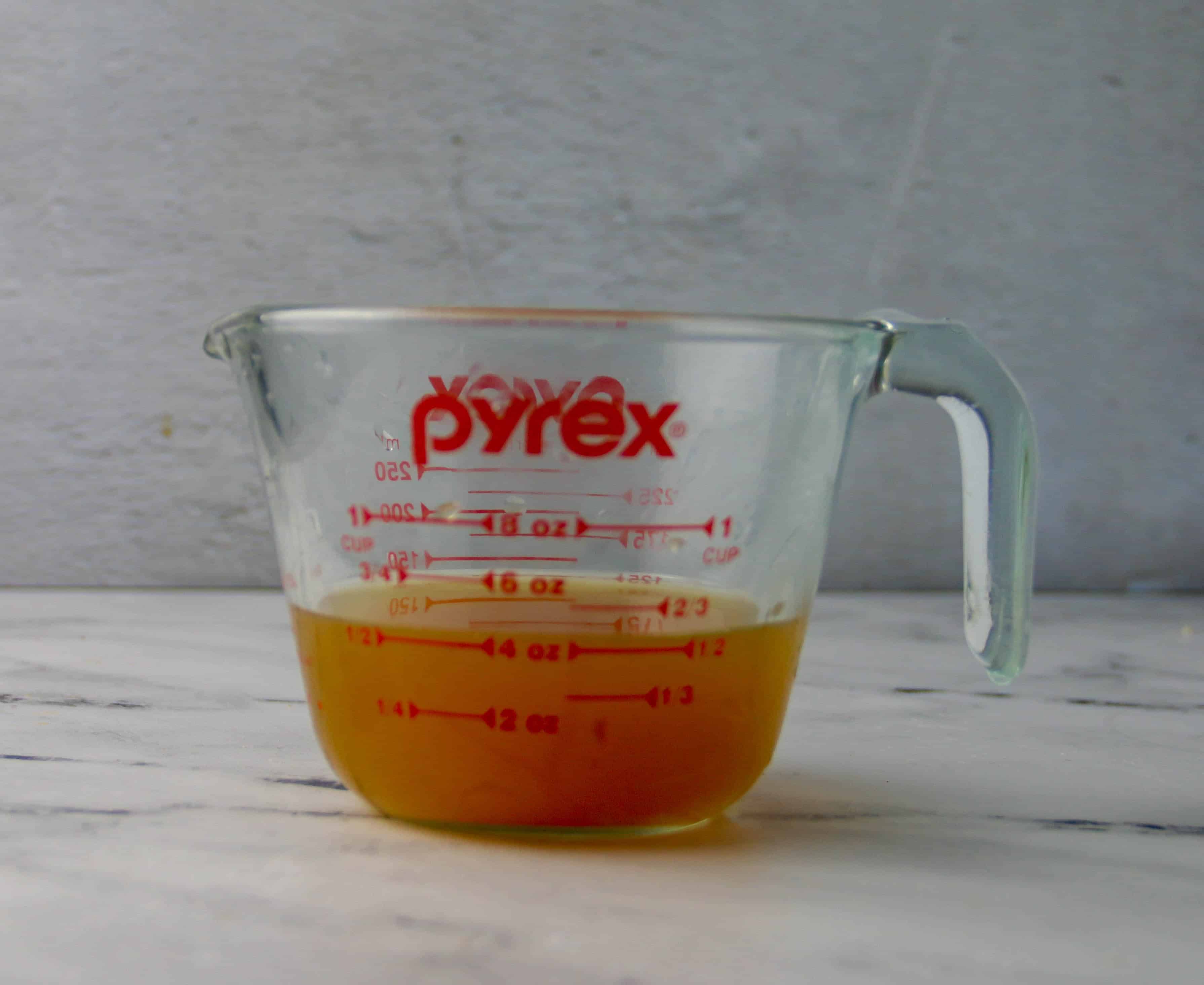 measuring cup of apple cider