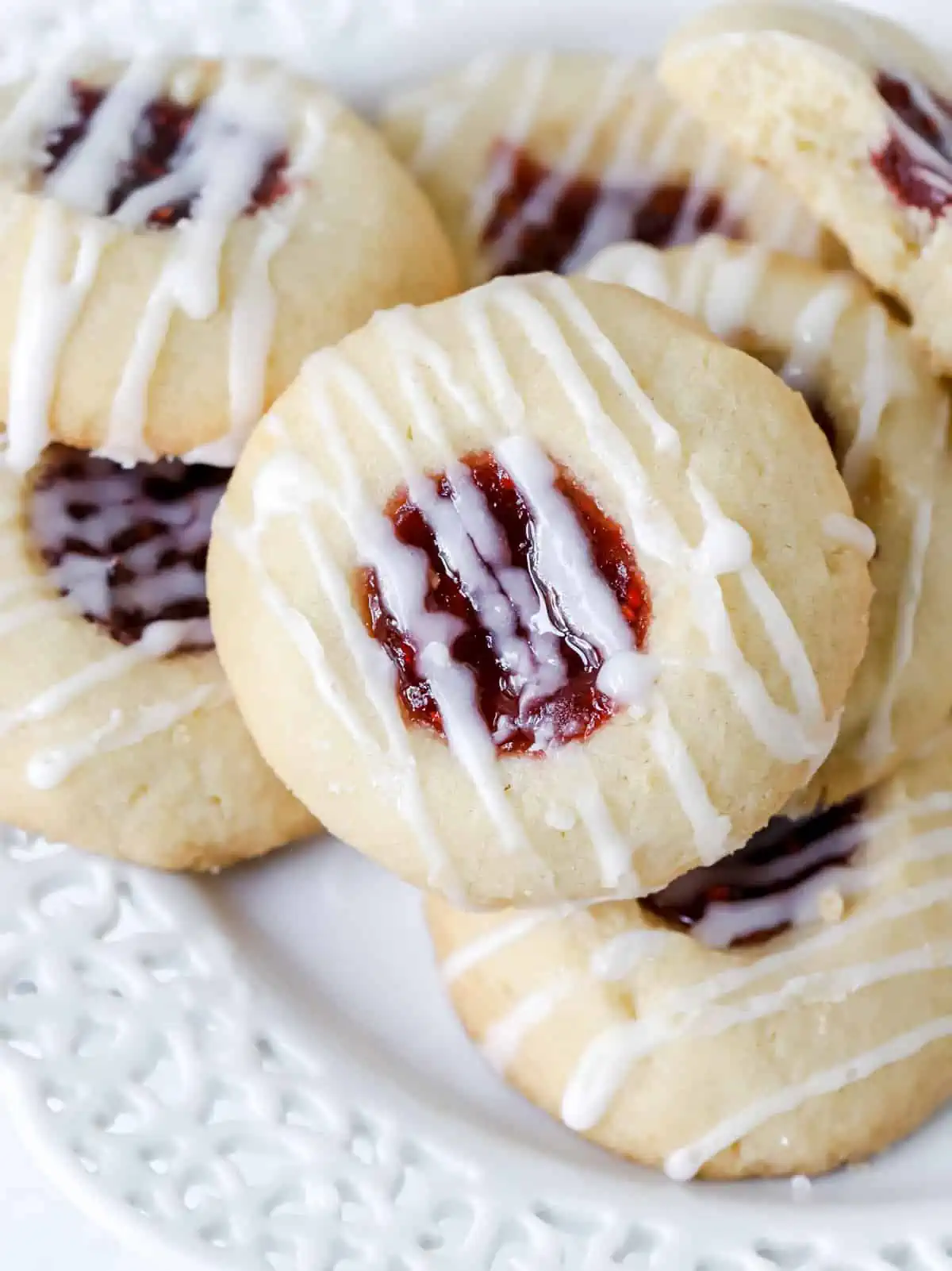 raspberry thumbprint cookies on a plate