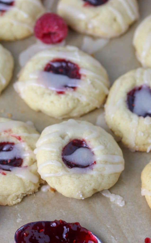 raspberry almond thumbprint cookies on parchment