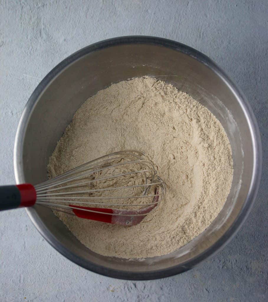 banana bread dry ingredients in a bowl with a whisk